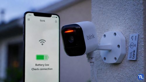 Eine Blink Outdoor Kamera mit rot leuchtender LED an einer Hauswand im Jahr 2026.